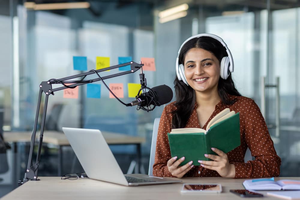 Author holding book while speaking on podcast