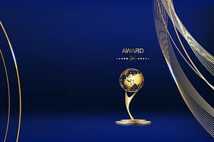 gold globe style award in front of blue background