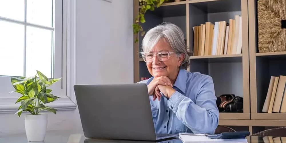 woman on podcast interview with books in background